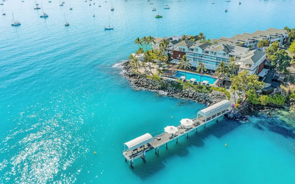 Aerial view of Coral Sea Resort, its pool and waterfront pier