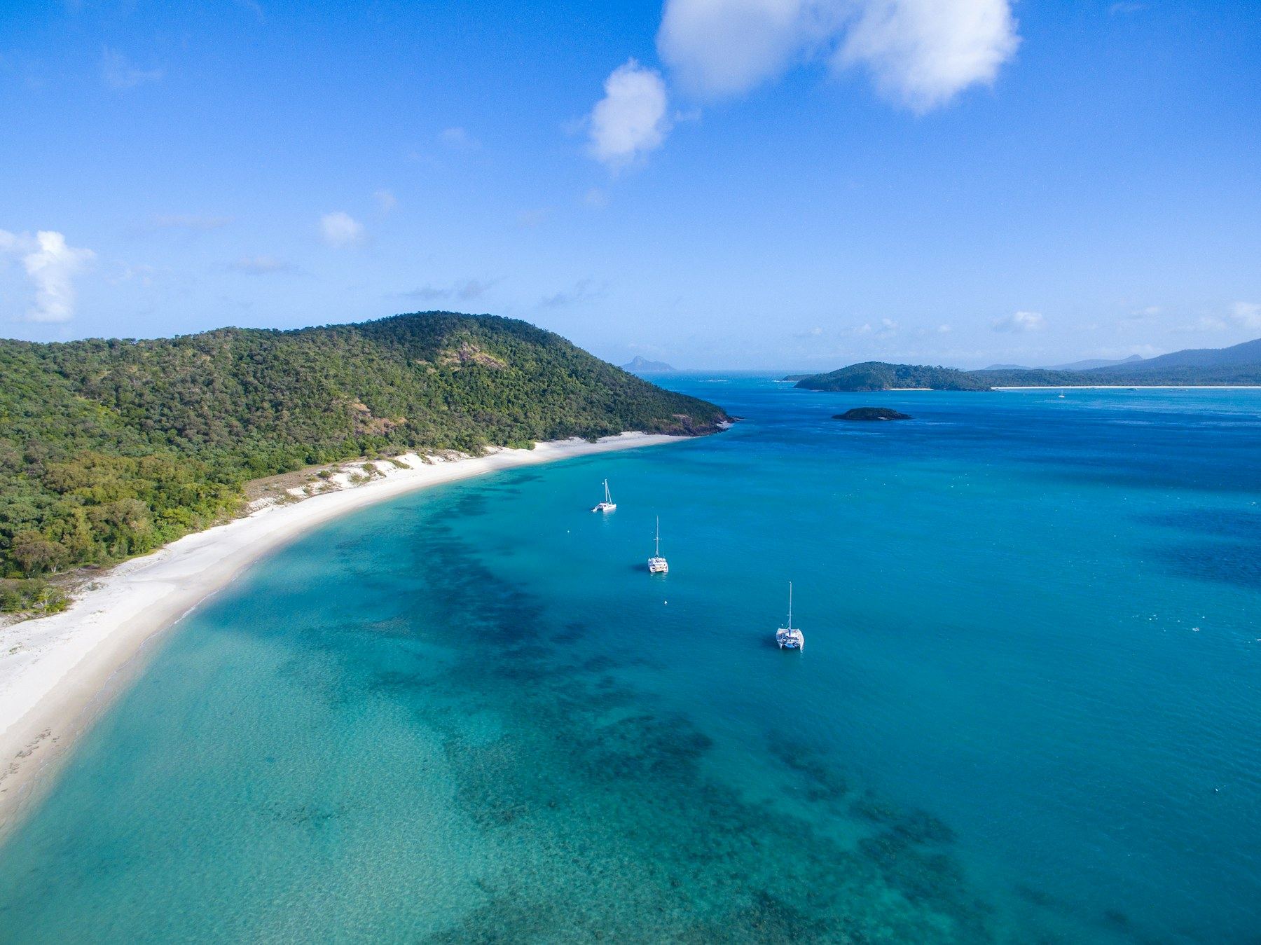 Whitsunday coastline, islands and anchored boats seen from above